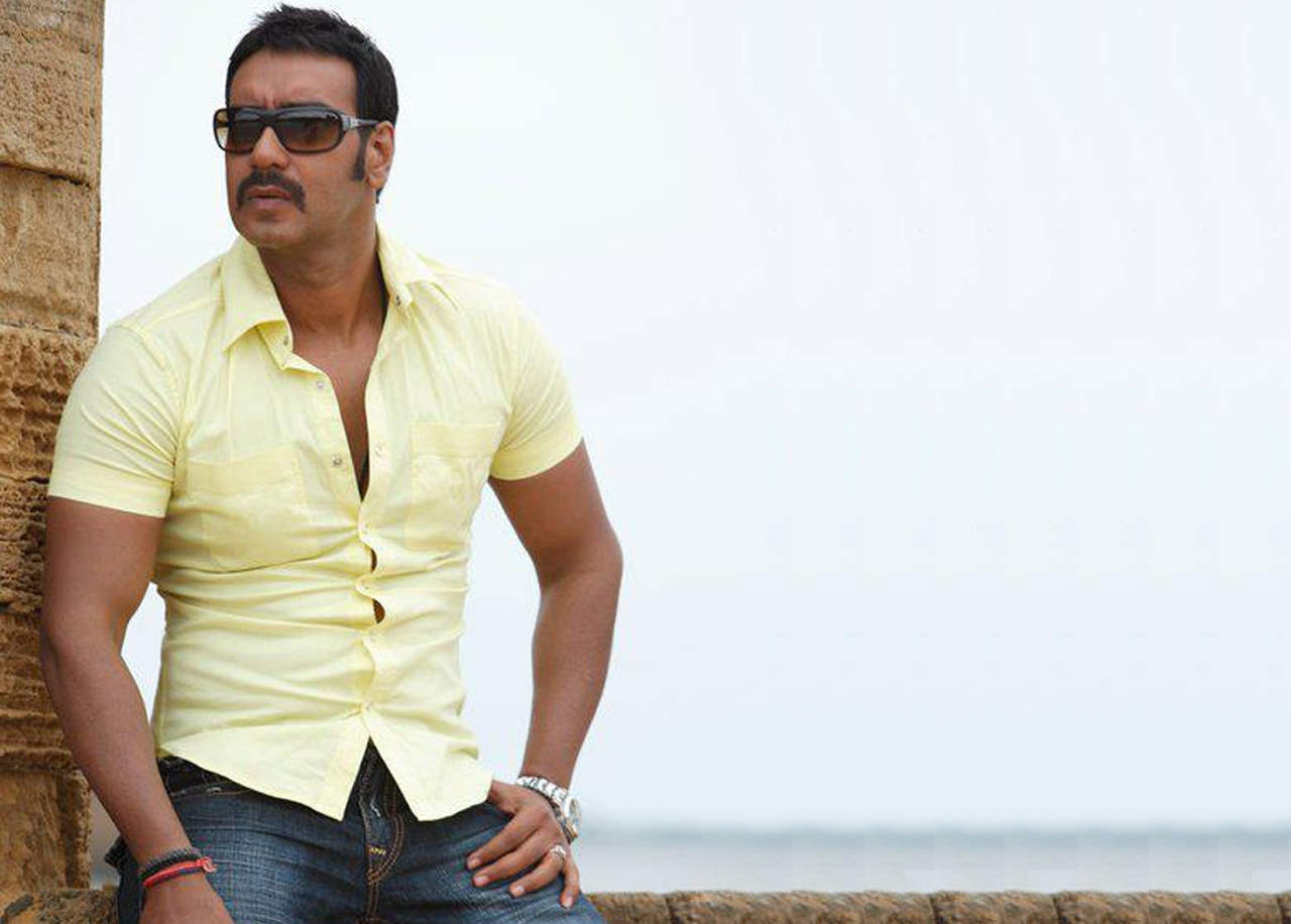 Ajay Devgan In Yellow Shirt And Blue Jeans