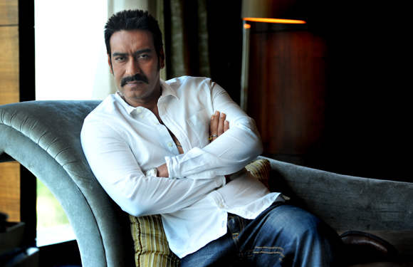 Ajay Devgan Wearing White Shirt And Blue Jeans