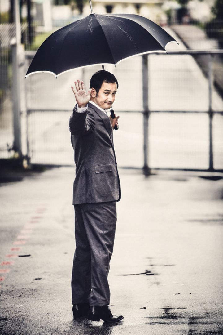 Gurmit Singh Holding Umbrella In His Hand