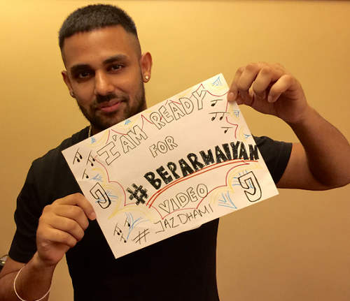 Jaz Dhami Holding A Paper