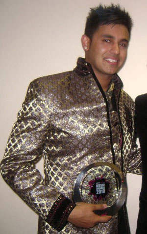 Jaz Dhami Holding Trophy