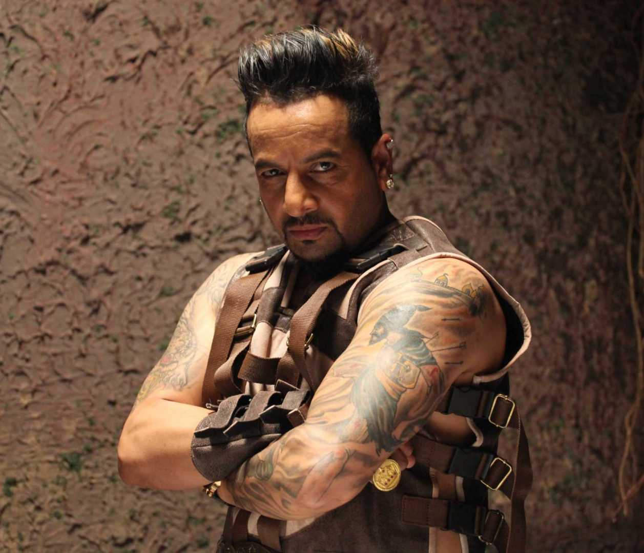Jazzy B Showing His Tattoo