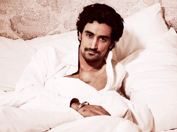 Actor Kunal Kapoor Laying On Bed