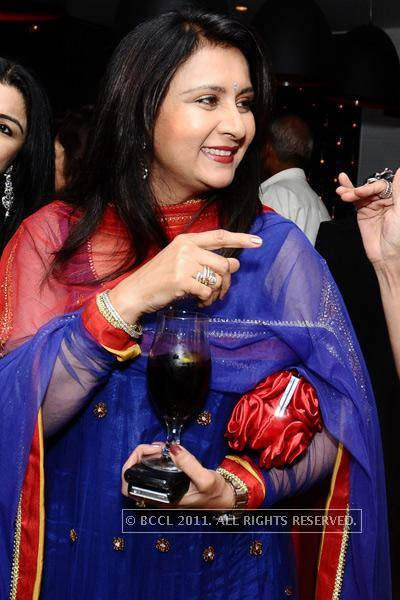 Poonam Dhillon Holding Glass And Mobile