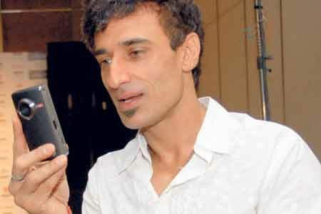 Rahul Dev Holding Camera