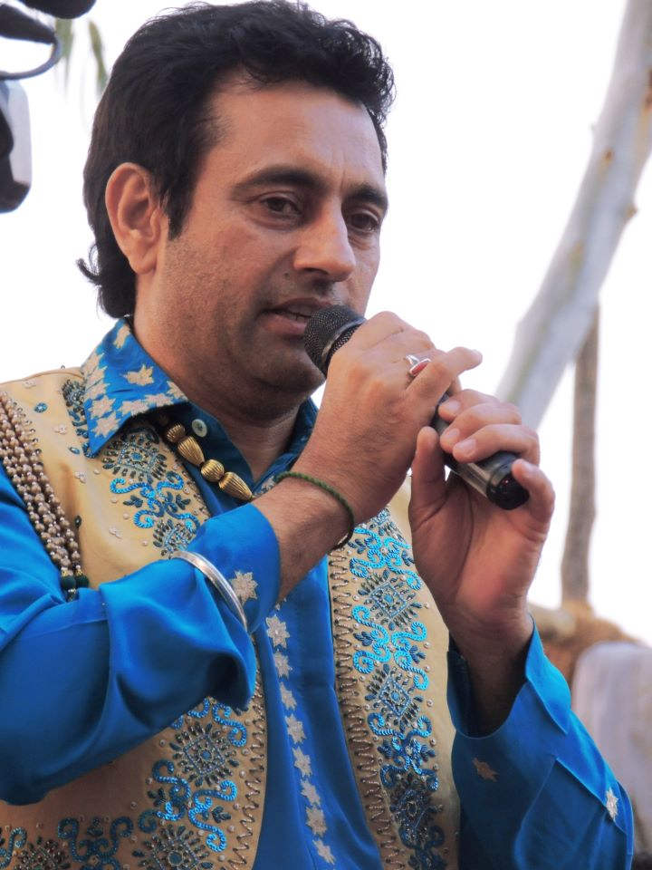 Singer Raj Brar Holding Mic
