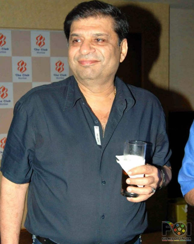 Director Ravi Chopra  Holding Glass