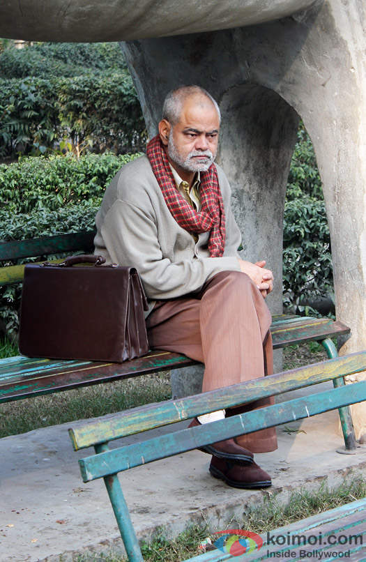 Sanjay Mishra Sitting On Table