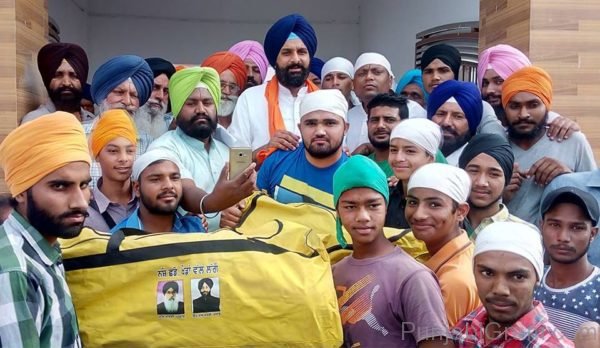 Bikram Singh Majithia giving sports kit bags to players