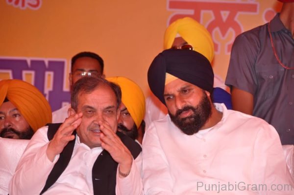 Bikram Singh Majithia sitting with minister