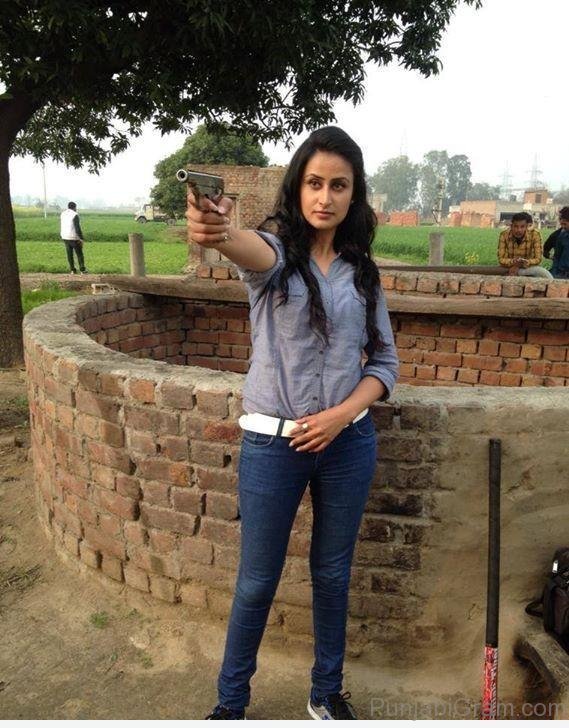 Jaspinder Cheema Holding Gun