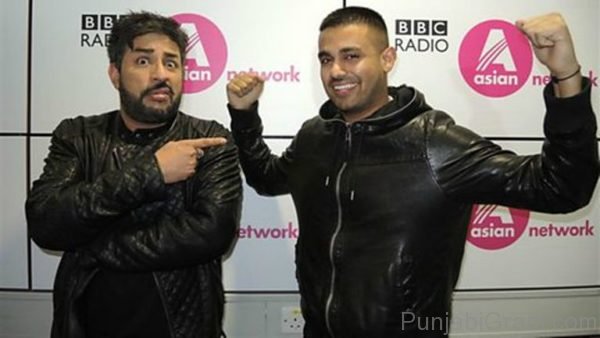 Jaz Dhami On Right side in Black Jacket